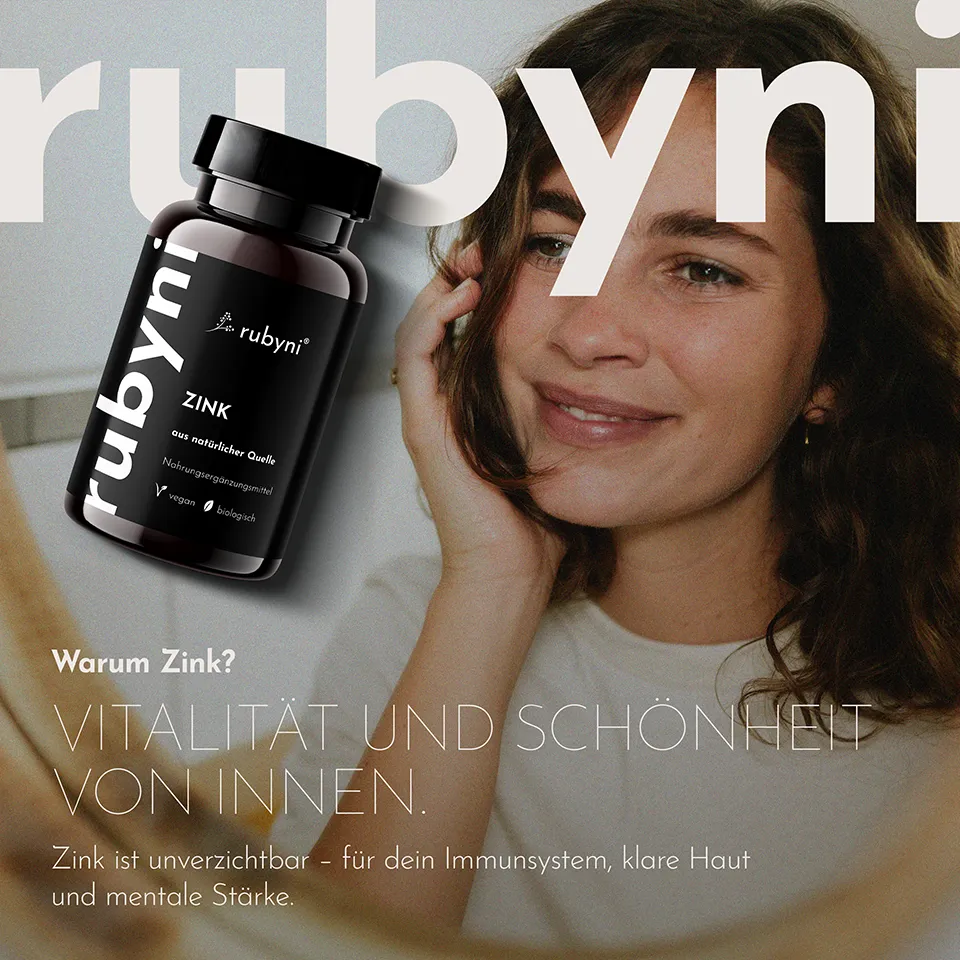 Werbemotiv für „rubyni Zink“ Eine dunkelbraune PET-Dose mit schwarzem Etikett (aus natürlicher Quelle, vegan, biologisch) ist links im Bild. Rechts lächelt eine Frau im Close-up. Im Bild steht: „Warum Zink? Vitalität und Schönheit von innen. Zink ist unverzichtbar – für dein Immunsystem, klare Haut und mentale Stärke.“